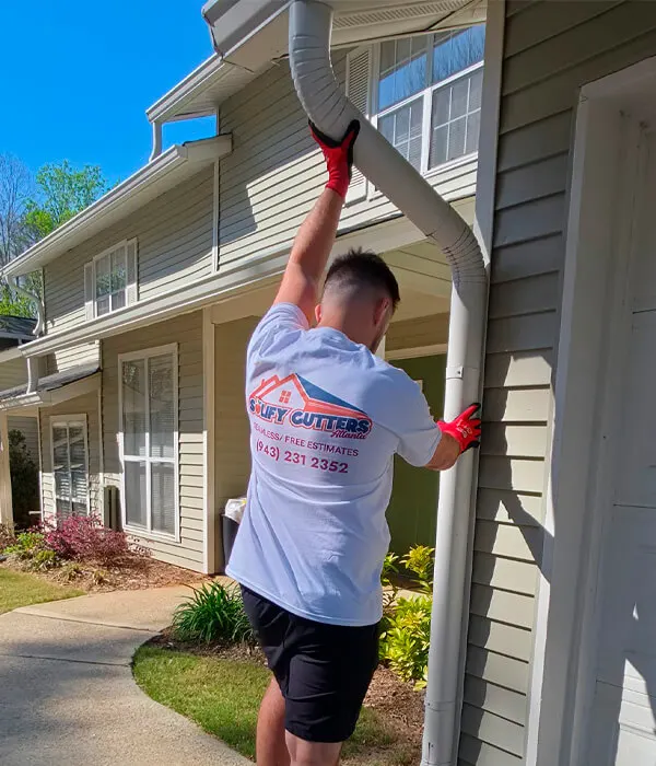 A Solify employee installing downspouts on the gutter